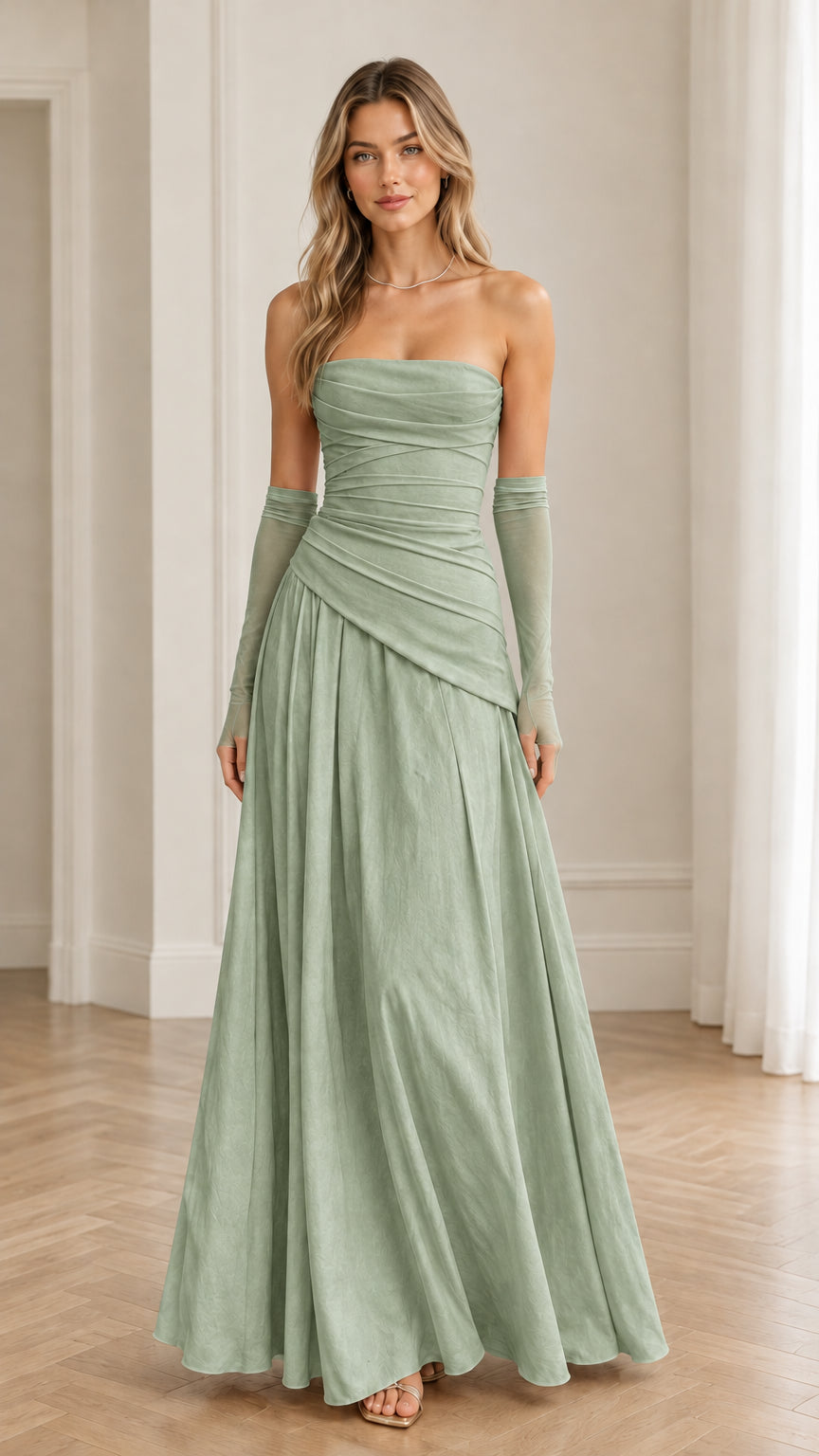 Model wearing sage green strapless ruched formal maxi gown with matching sheer gloves