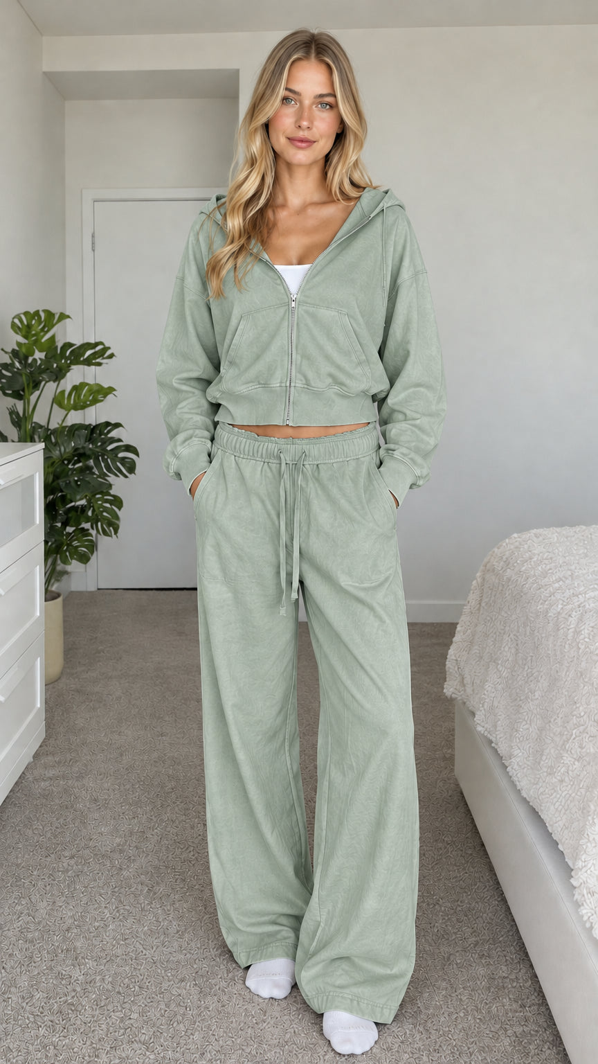 Model wearing sage green cropped zip hoodie and wide-leg sweatpants set