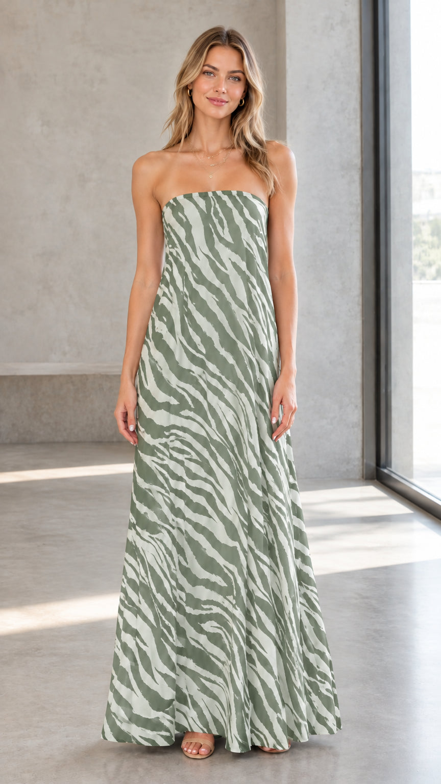 Front view of model wearing sage green and white zebra print strapless maxi dress