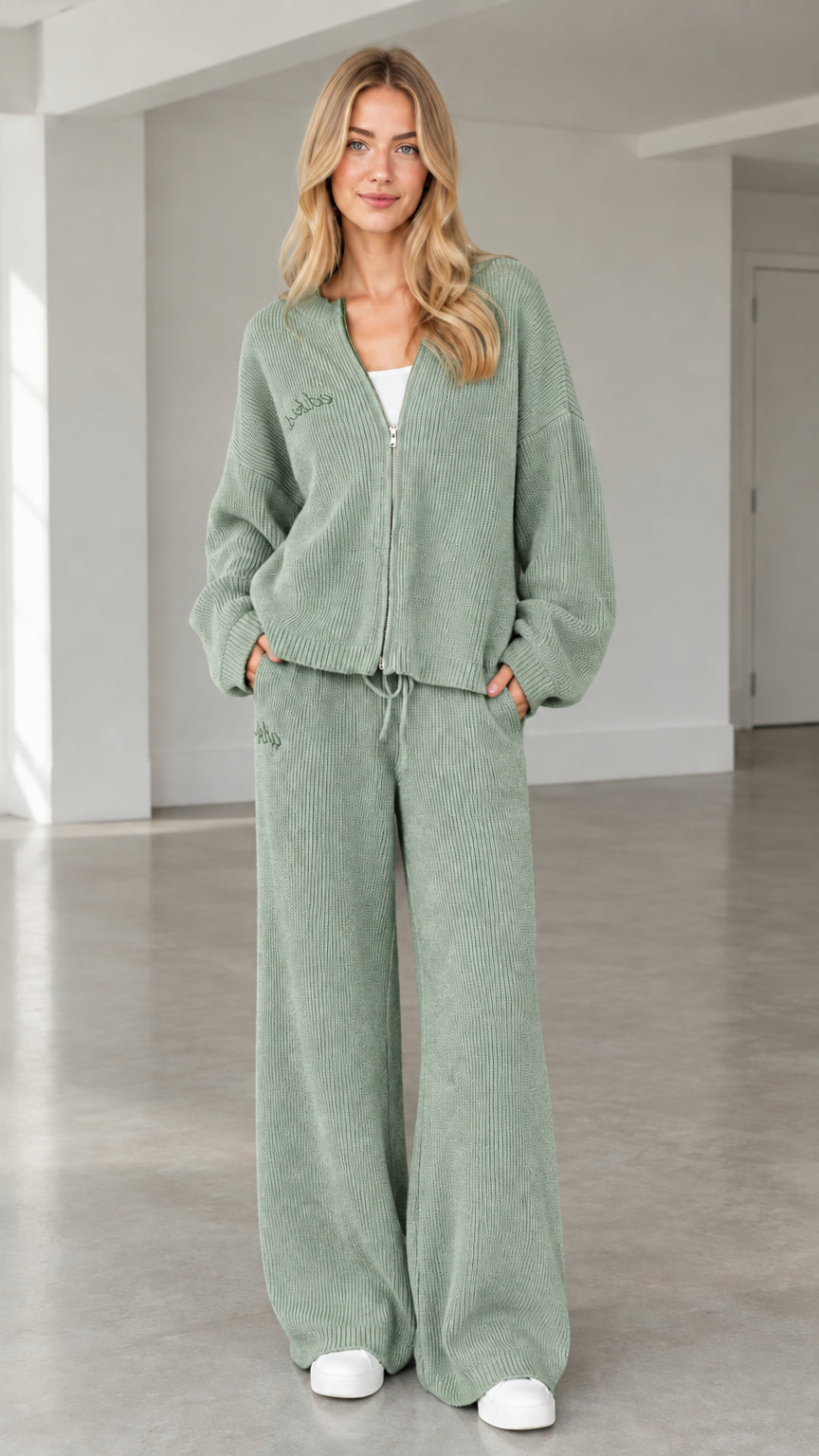 Front full view of woman wearing sage green ribbed knit zip-up cardigan and wide-leg pants set
