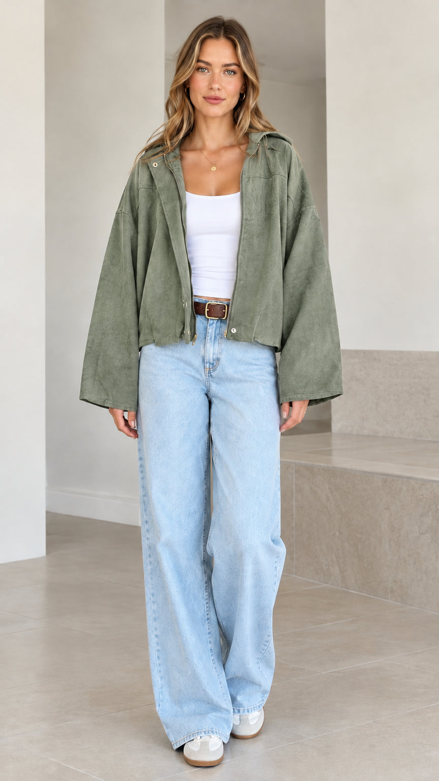 Model wearing sage green cropped hooded jacket with relaxed flared sleeves