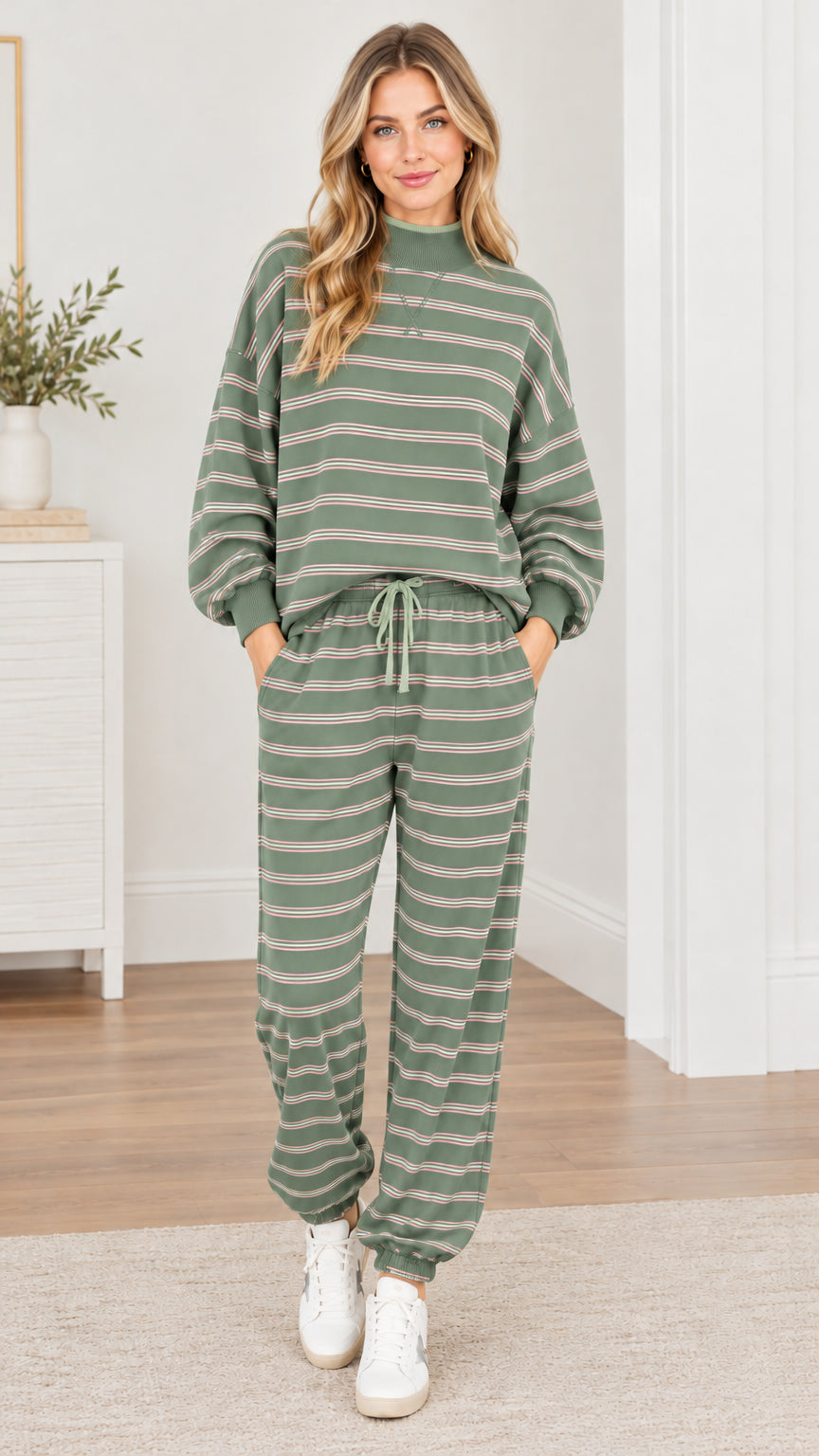 Woman wearing sage green striped 2-piece sweatshirt and jogger pants set