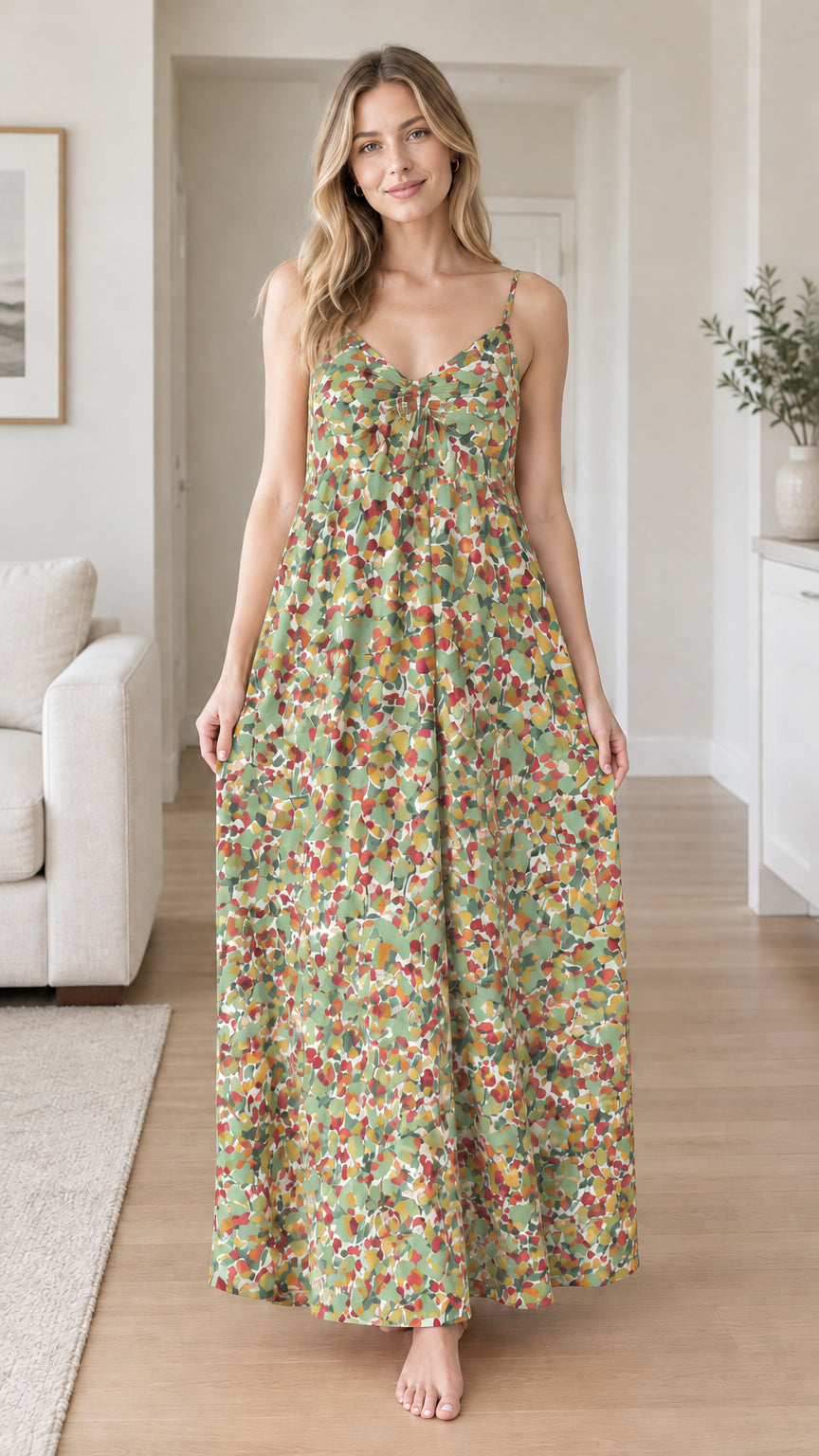 Front view of woman wearing sage green floral backless maxi dress