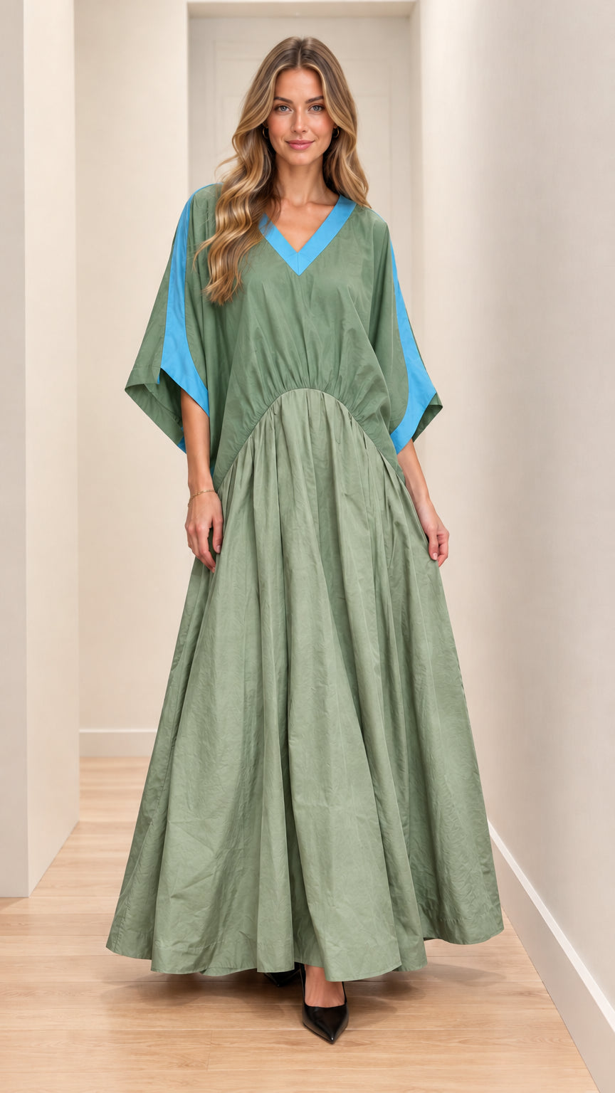 Front full-length view of model wearing sage green maxi dress with blue contrast trim