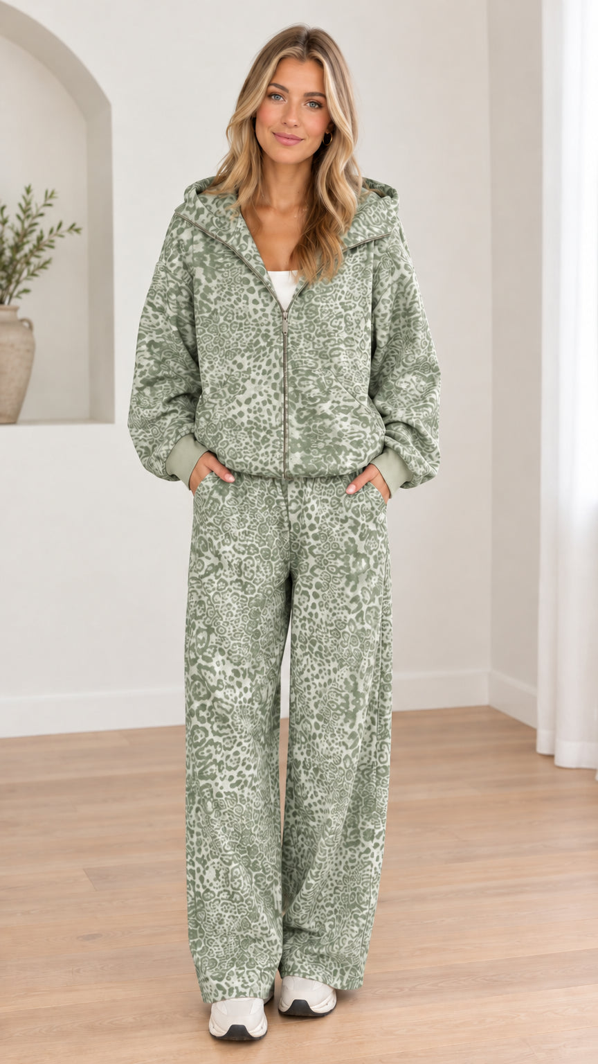 Woman wearing sage green leopard print hooded zip-up jacket and wide-leg pants set