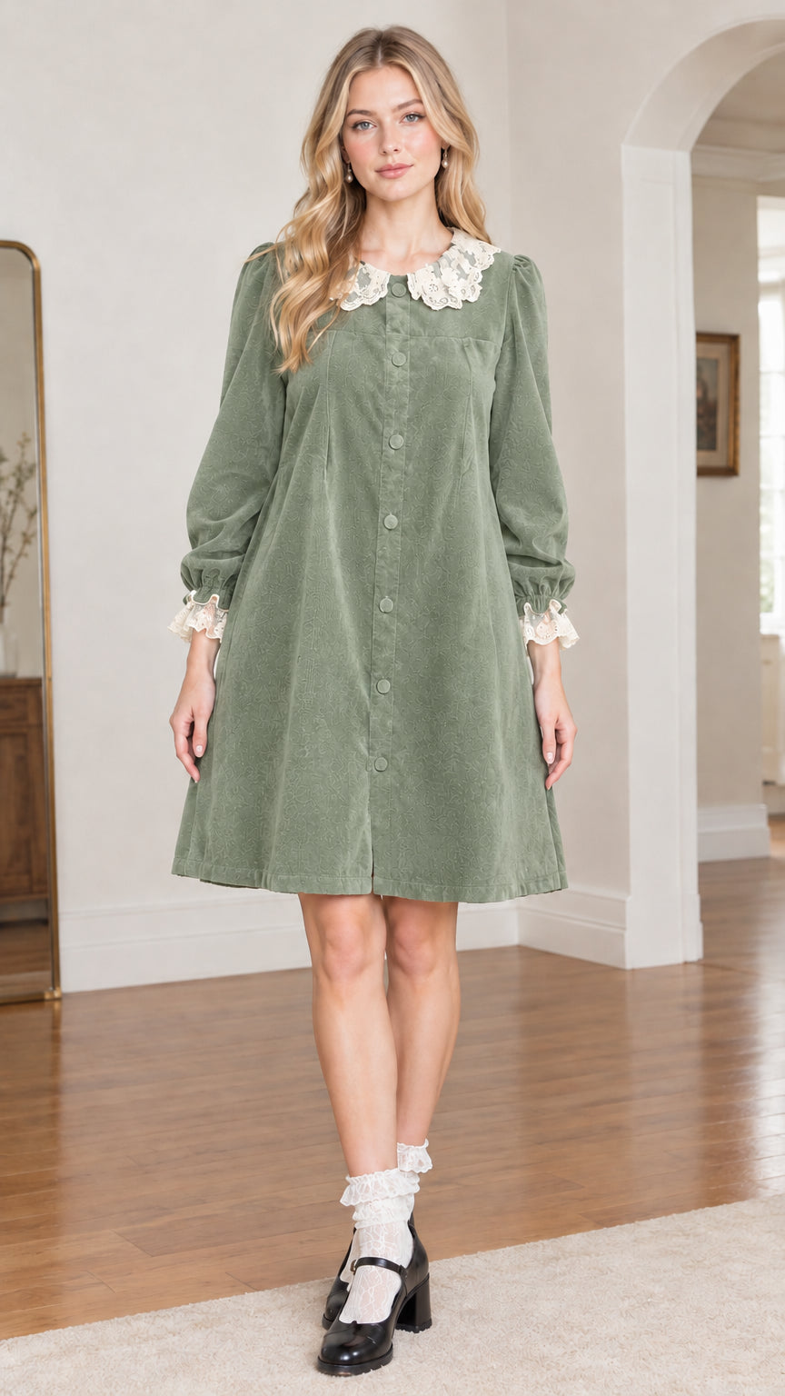 Front view of model wearing sage green velvet babydoll dress with lace collar