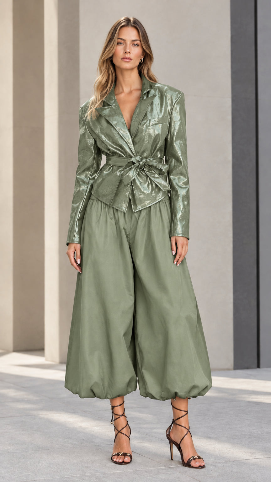 Front view of model wearing sage green glossy belted blazer and olive balloon pants set