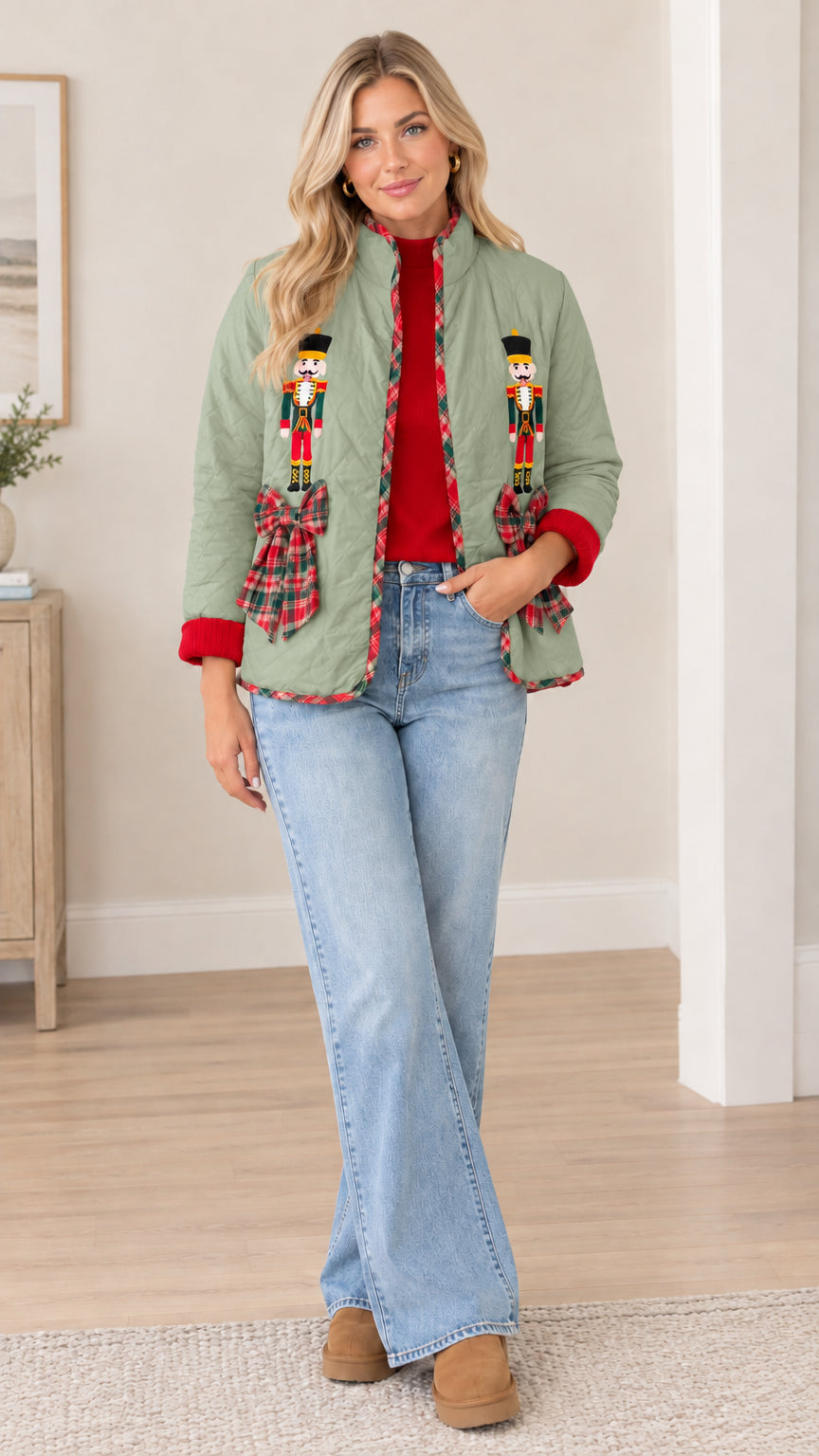 Model wearing sage green quilted holiday jacket with nutcracker embroidery