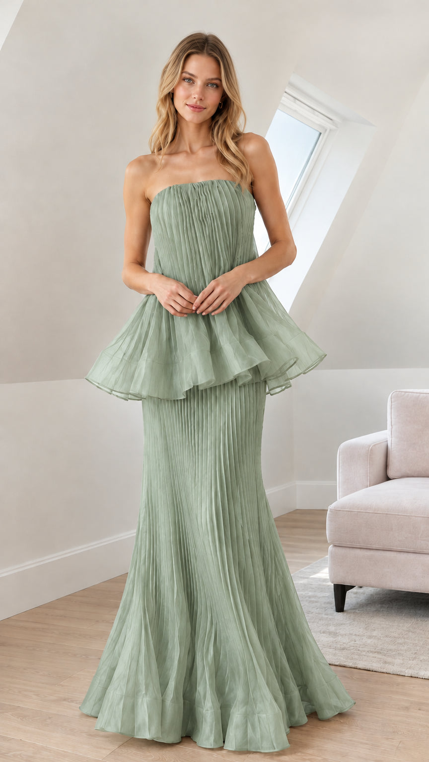 Front view of woman wearing sage green strapless pleated peplum maxi gown