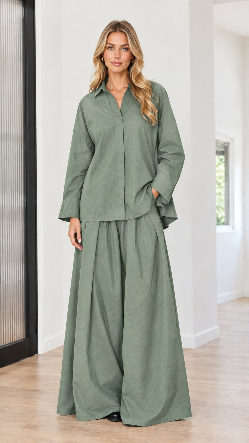 Model wearing sage green collared long sleeve top and flowing wide-leg pants set
