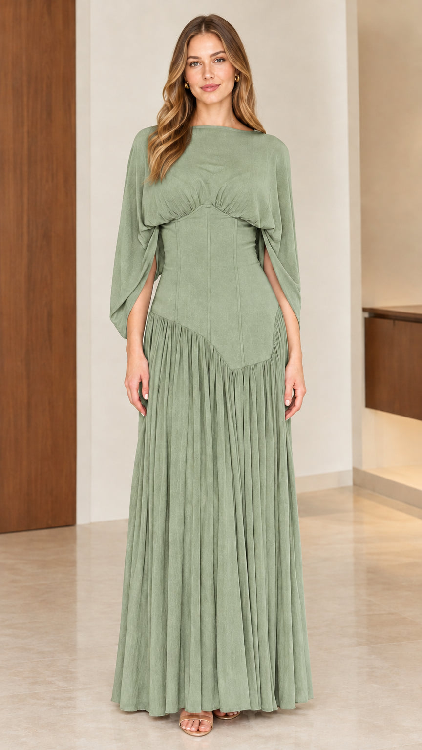 Full-length front view of model wearing sage green pleated formal maxi gown