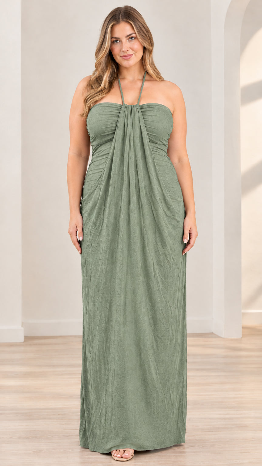 Front full-length view of model wearing sage green halter draped maxi dress