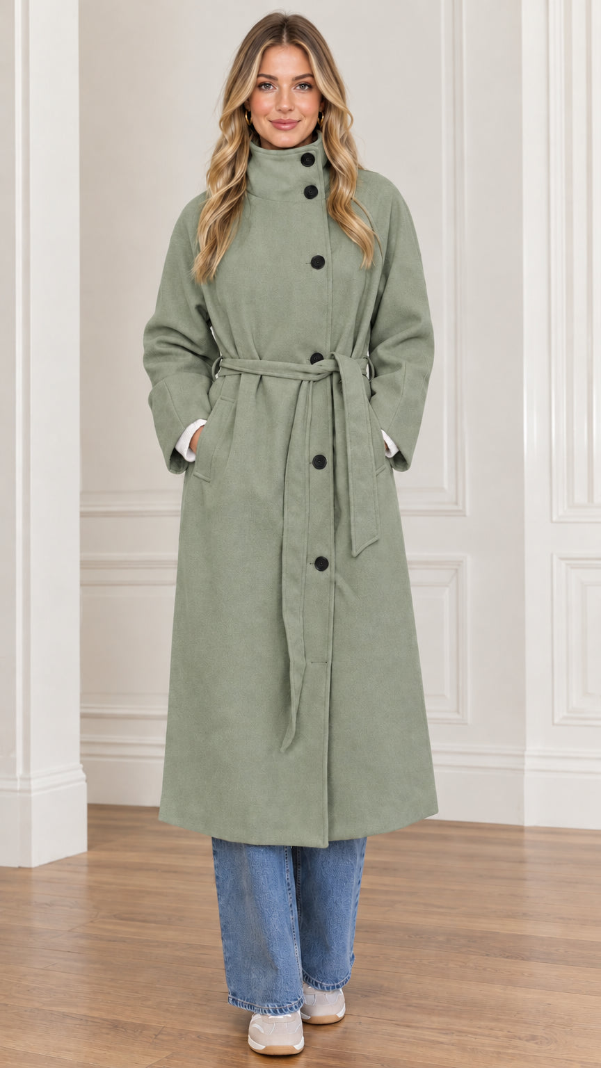 Front view of woman wearing sage green high neck belted long overcoat
