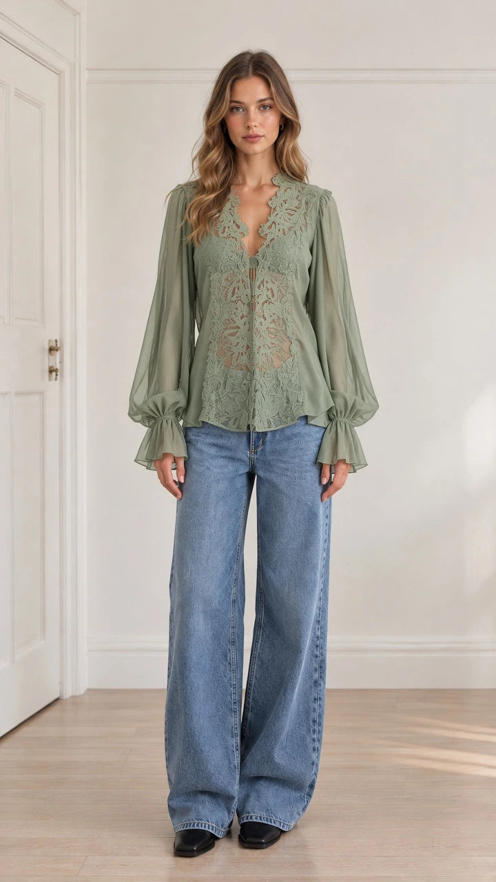 Model wearing sage green floral lace long sleeve blouse paired with wide-leg blue jeans