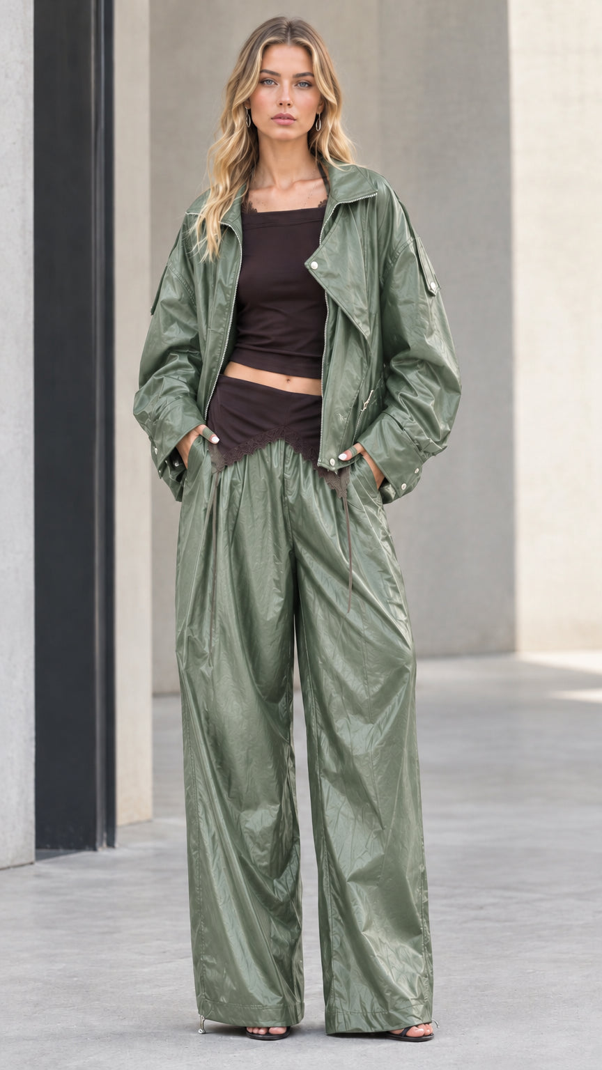 Full front view of model wearing sage green crinkle metallic jacket and wide leg pants set