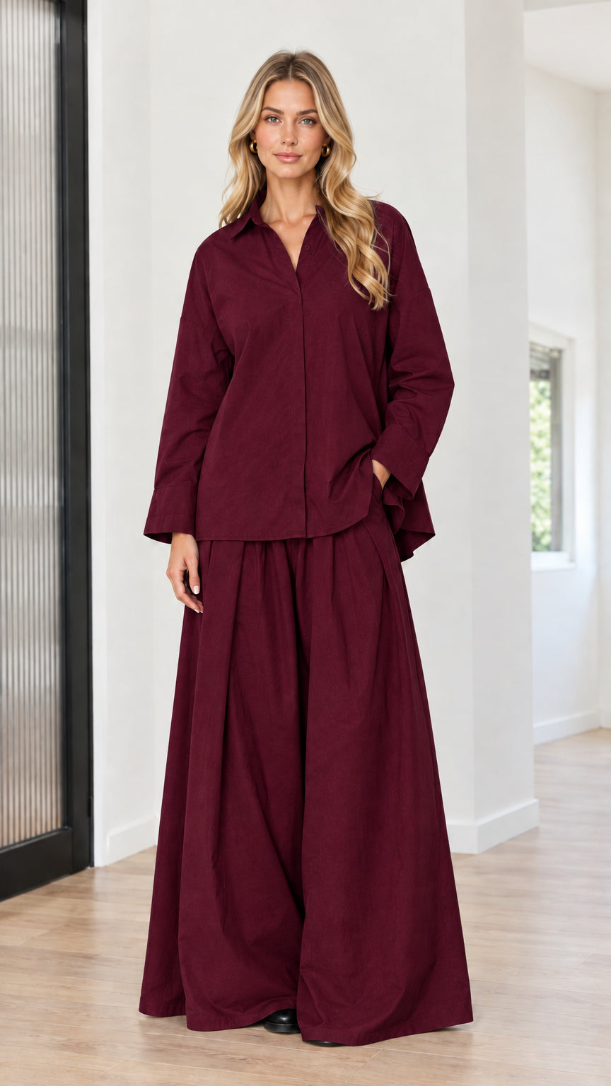 Model wearing burgundy button-front tunic top and wide-leg pleated palazzo pants set