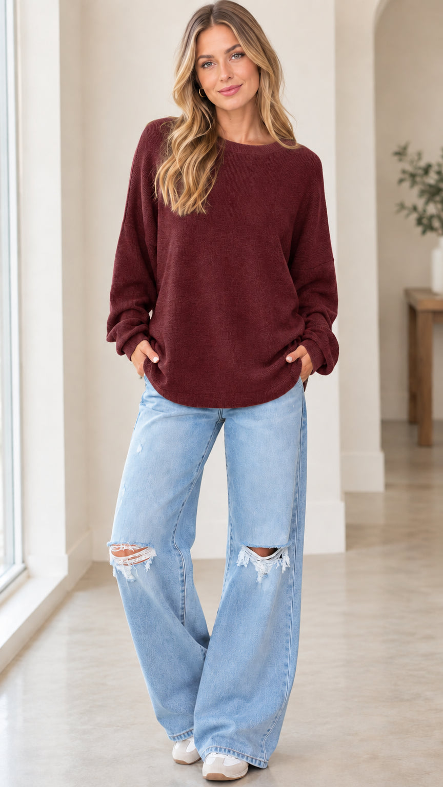 Front full view of woman wearing burgundy wine crewneck knit pullover sweatshirt