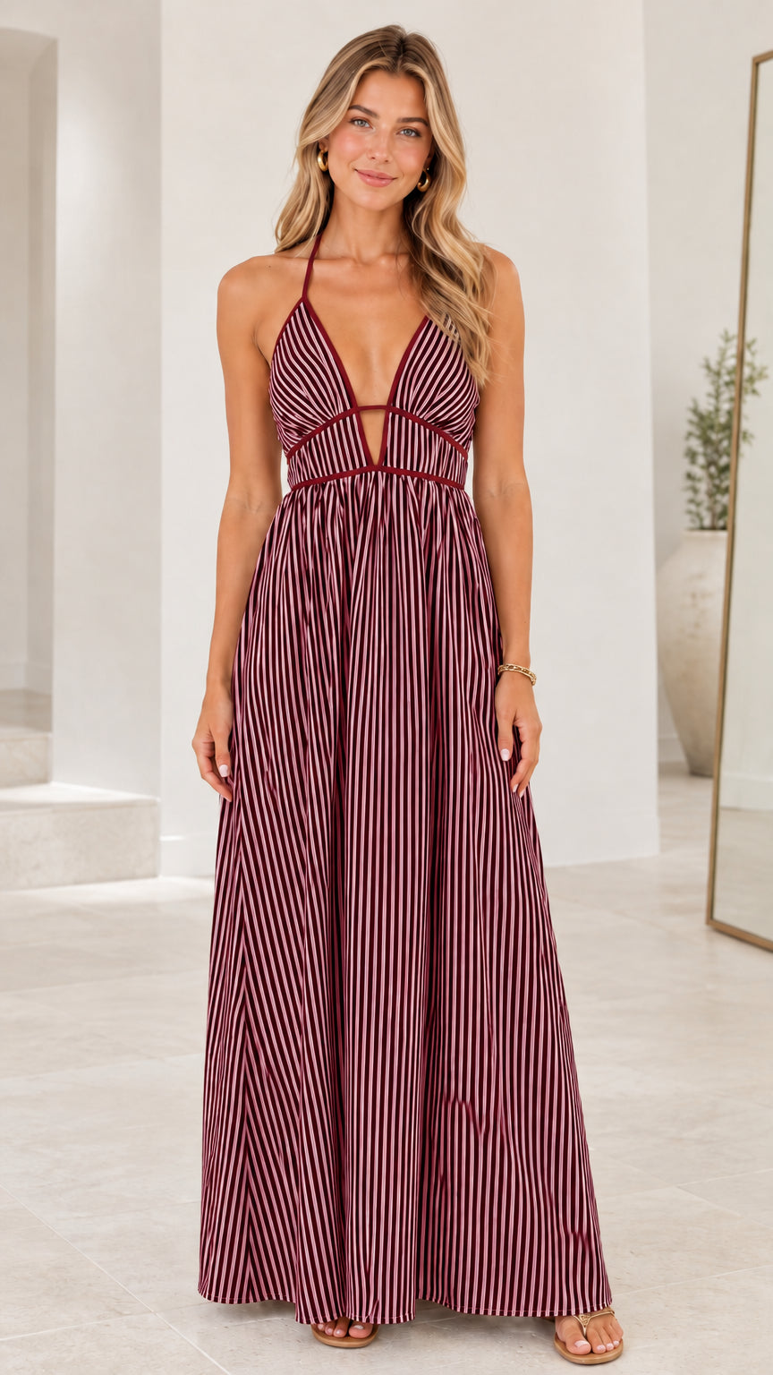 Front view of model wearing Burgundy striped halter cut-out maxi dress