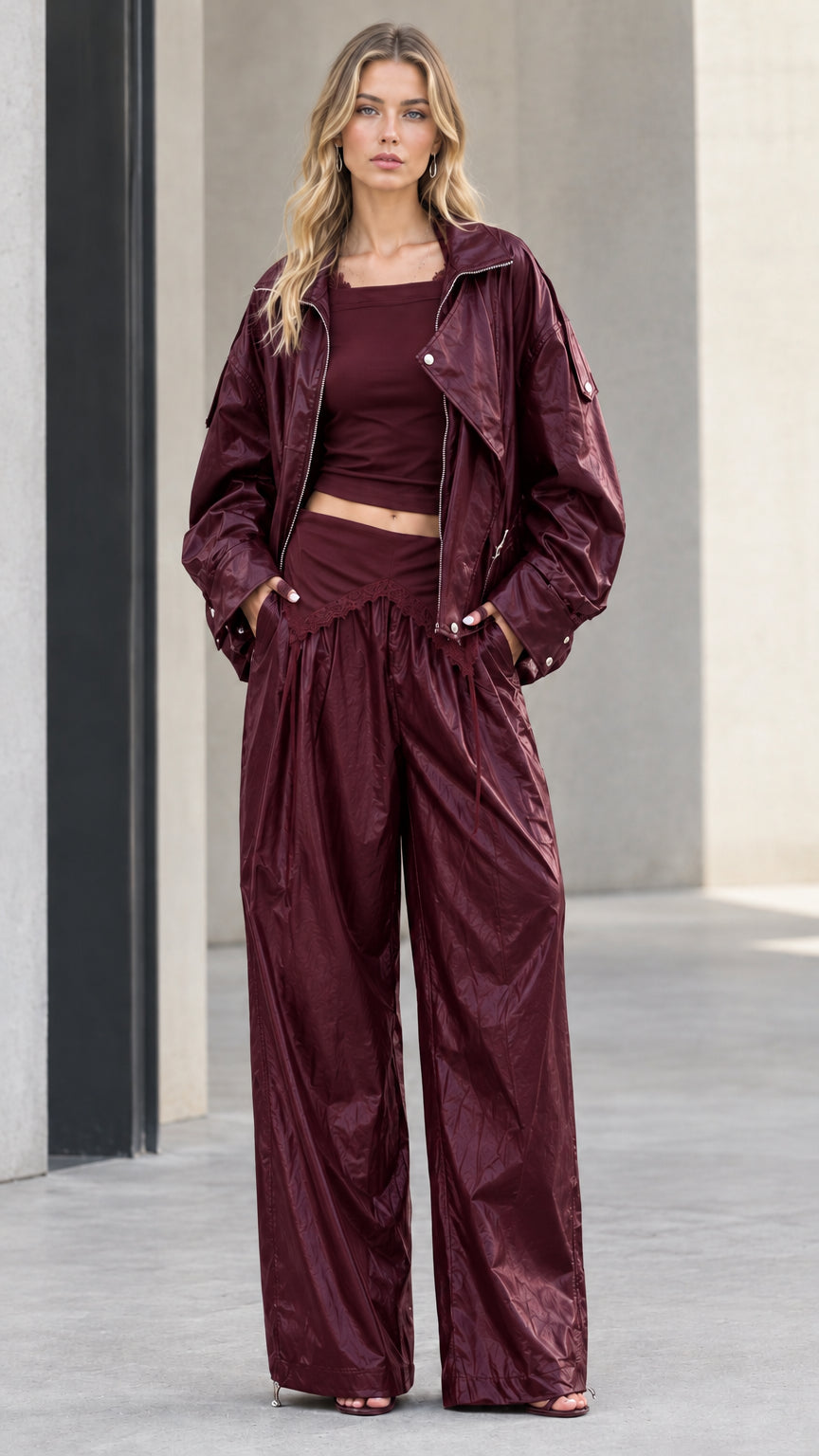 Full front view of model wearing burgundy crinkle metallic jacket and wide leg pants set