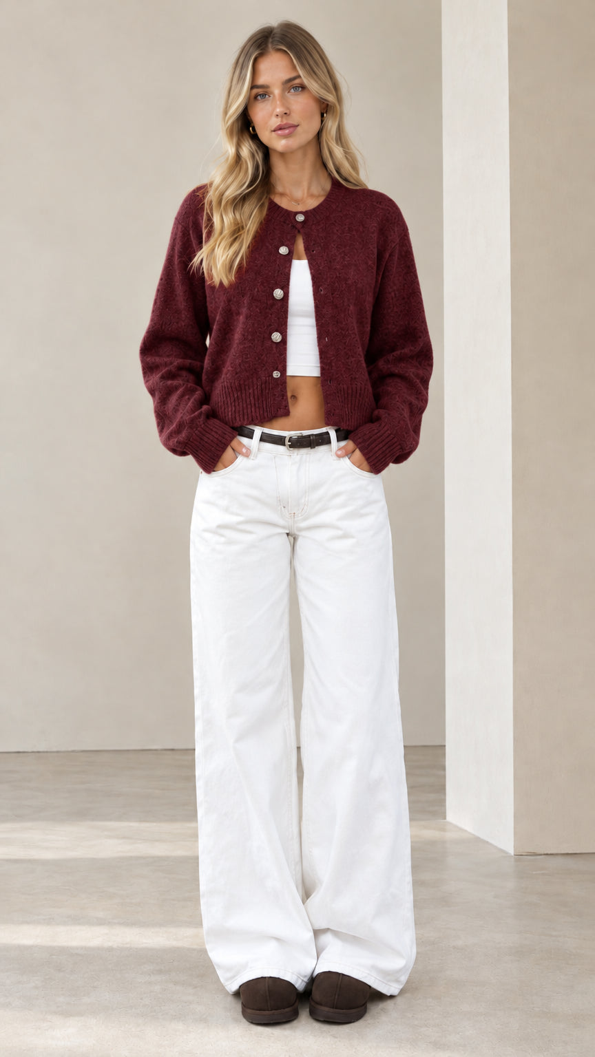 Model wearing burgundy wine red cropped knit cardigan with silver-tone buttons