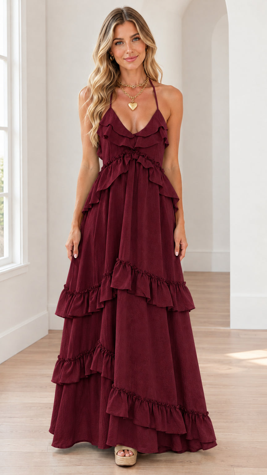 Front view of burgundy wine tiered ruffle halter maxi dress on model