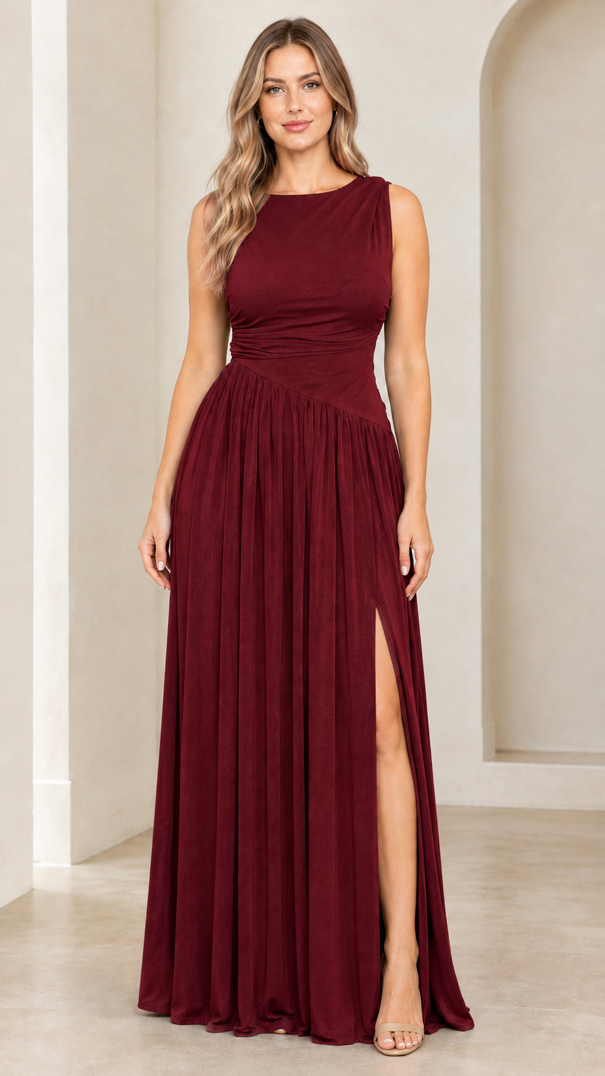 Front full-length view of woman wearing burgundy wine red sleeveless cowl back pleated maxi dress