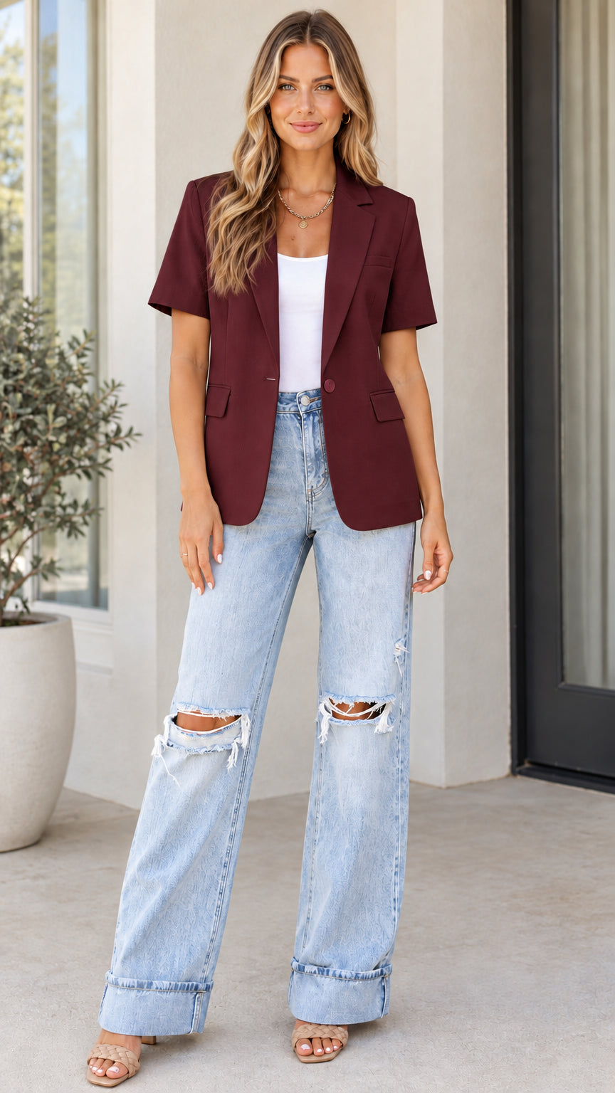 Model wearing burgundy short sleeve tailored blazer with jeans and heels
