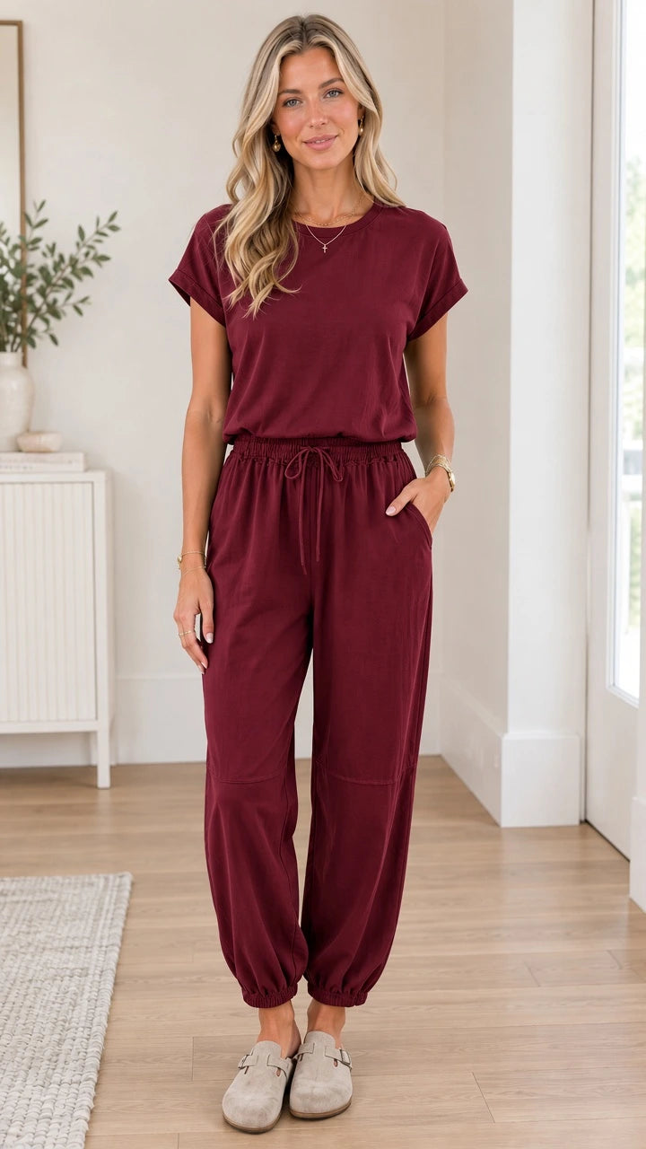 Front full view of woman wearing wine red short sleeve casual jogger jumpsuit