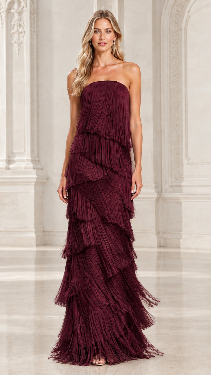 Front view of model wearing burgundy wine strapless tiered fringe maxi evening gown