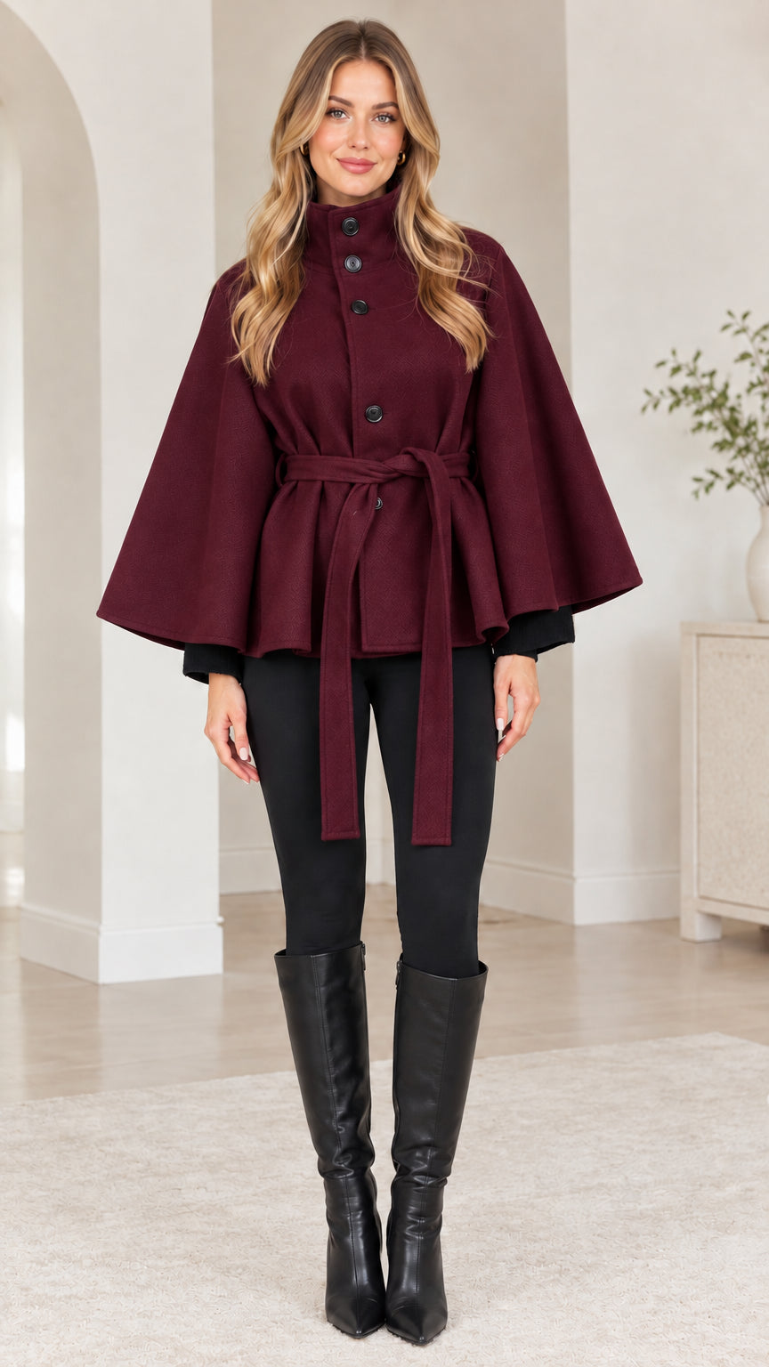 Front view of woman wearing burgundy wine red belted cape coat
