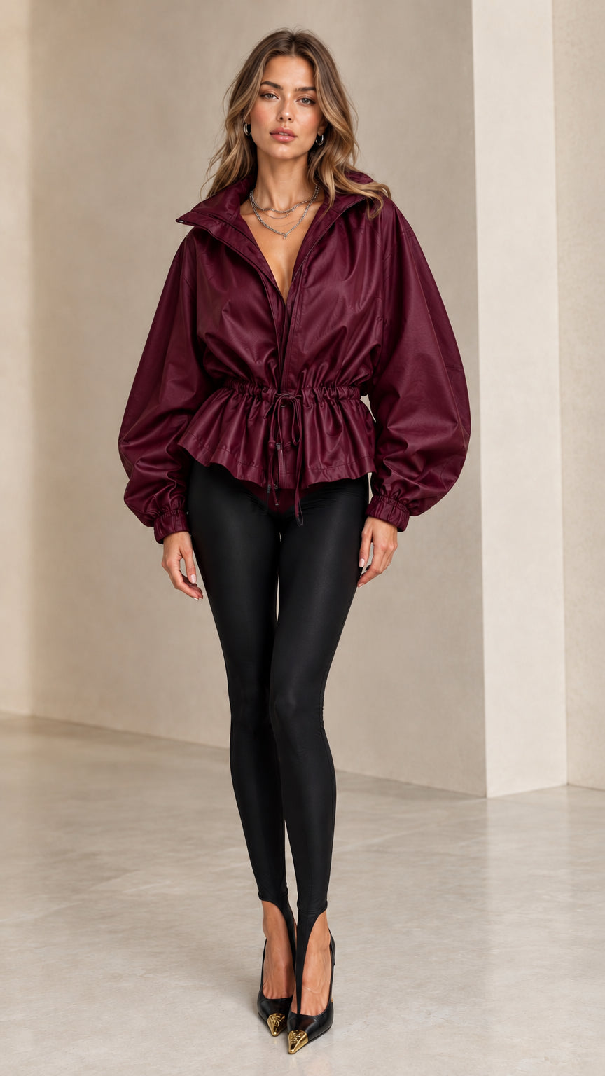 Front view of model wearing burgundy drawstring waist peplum jacket