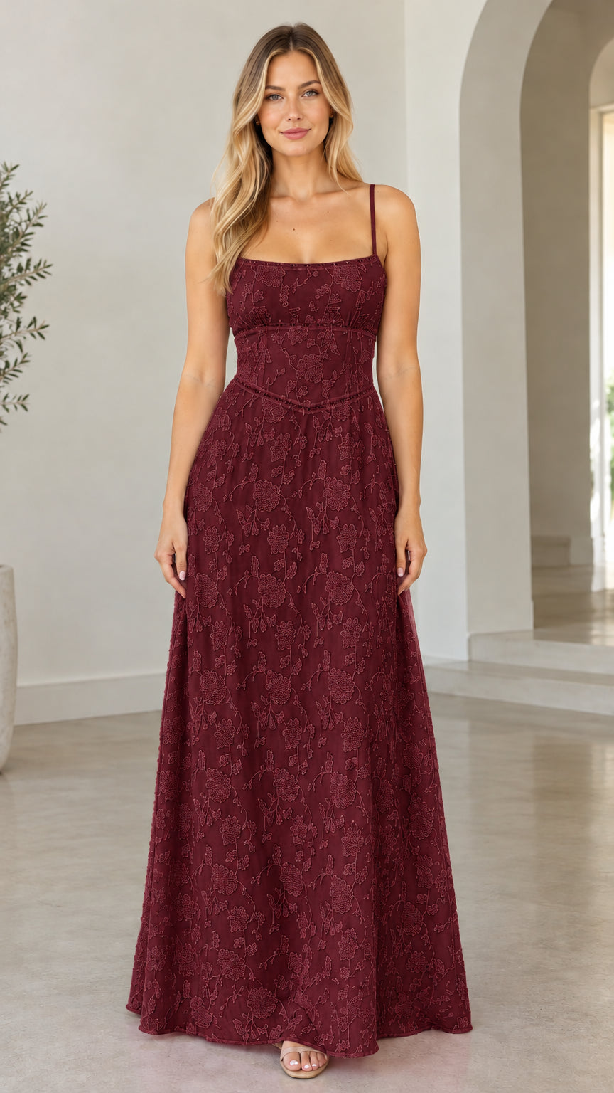 Front view of model wearing burgundy floral jacquard tie-back maxi dress