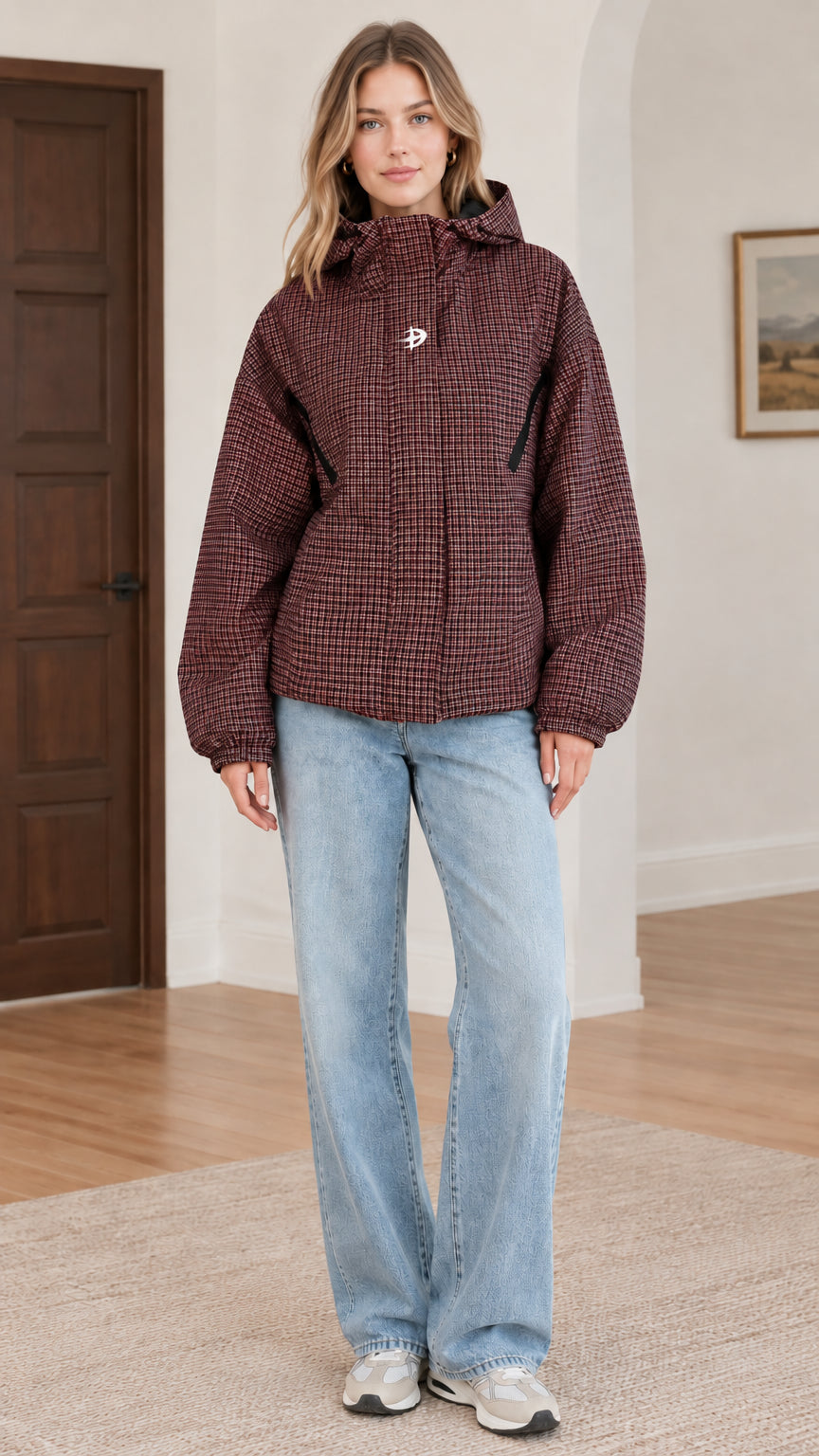Front view of burgundy red houndstooth hooded jacket styled with light blue jeans