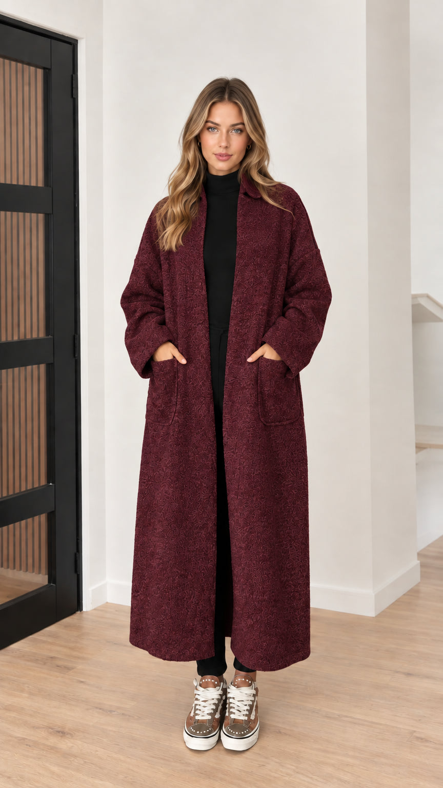 Front view of model wearing burgundy wine textured long coat