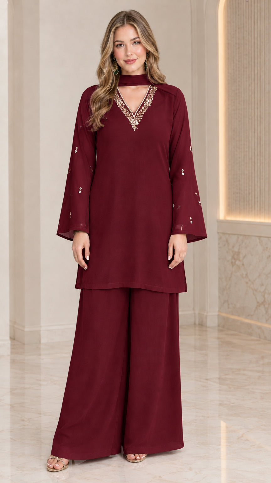 Front full-length view of model wearing burgundy wine embellished tunic and wide-leg pant set