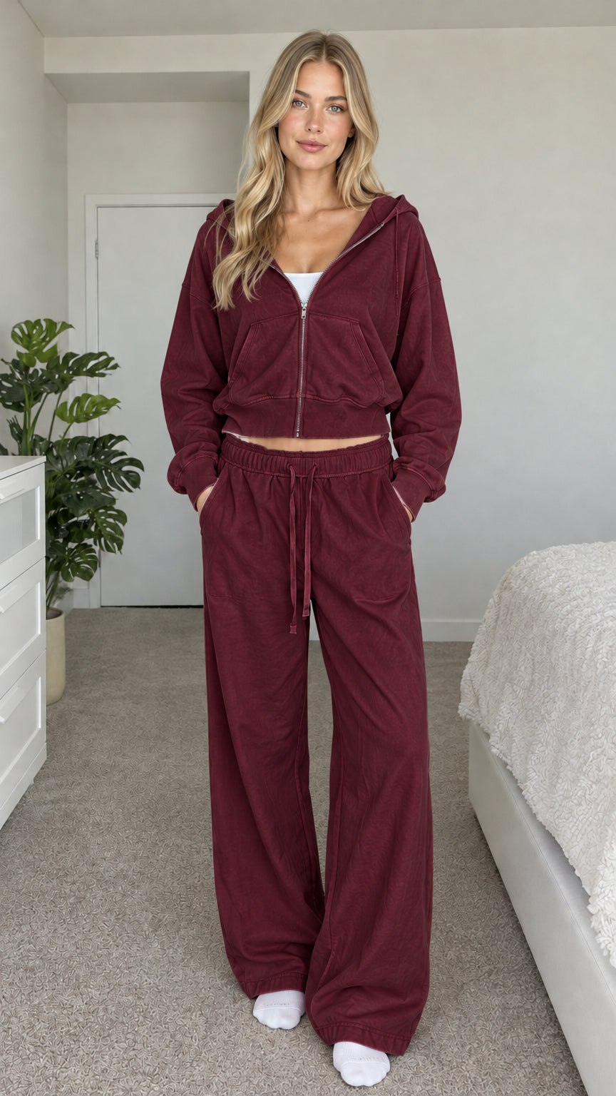 Model wearing burgundy cropped zip hoodie and wide-leg sweatpants set