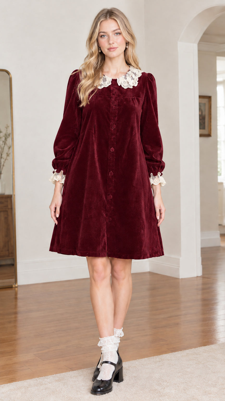 Front view of model wearing burgundy wine velvet babydoll dress with lace collar
