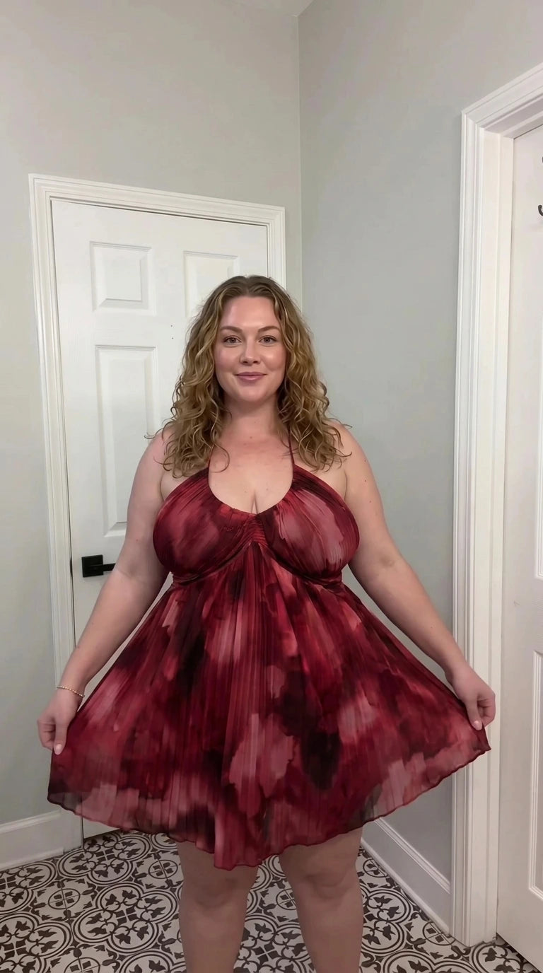 Front view of burgundy multi watercolor pleated halter babydoll mini dress