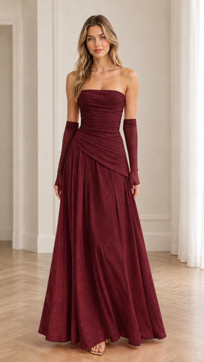 Model wearing burgundy wine strapless evening gown with matching sheer opera gloves