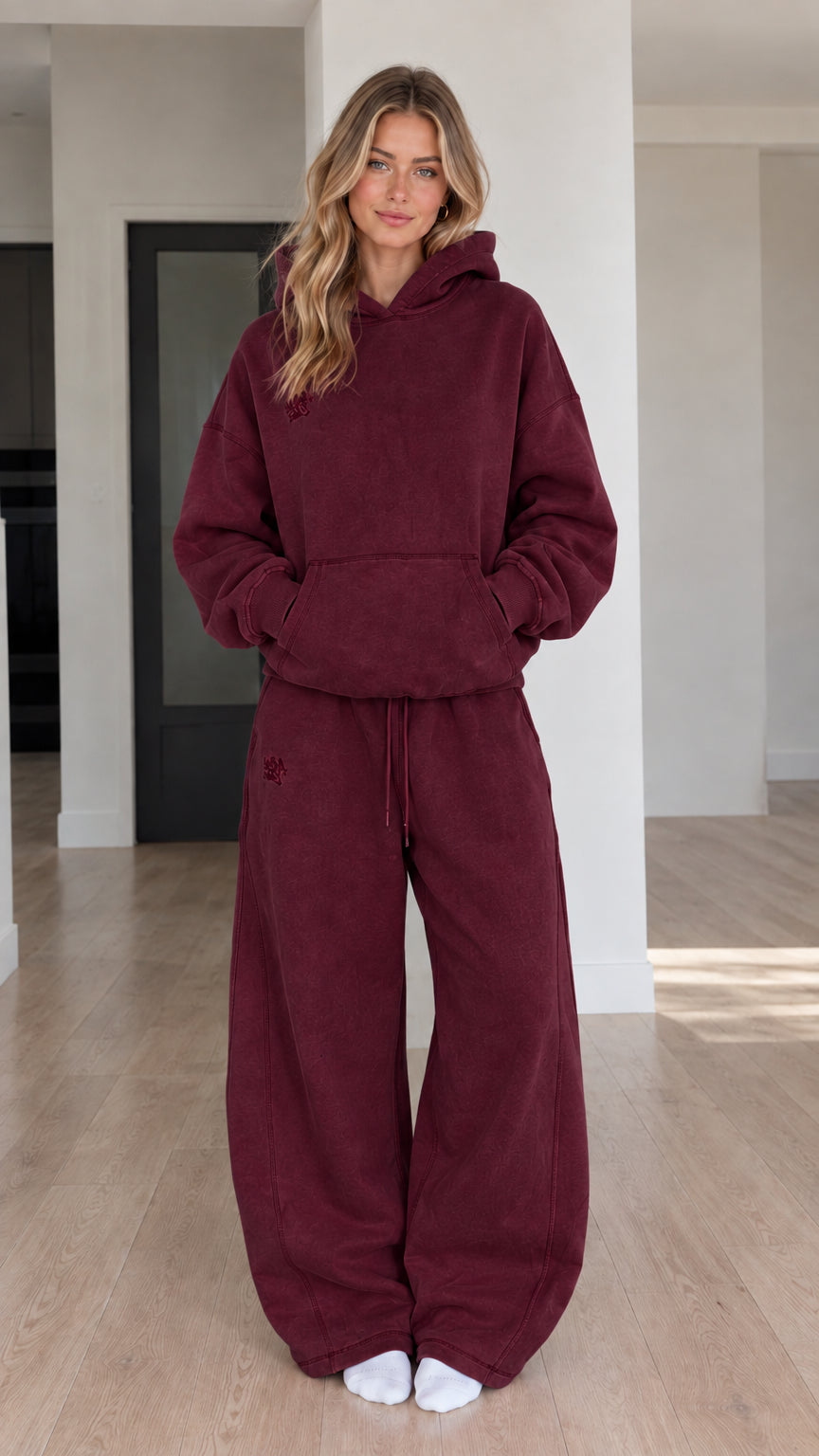 Front view of model wearing Burgundy oversized hoodie and wide-leg sweatpants set