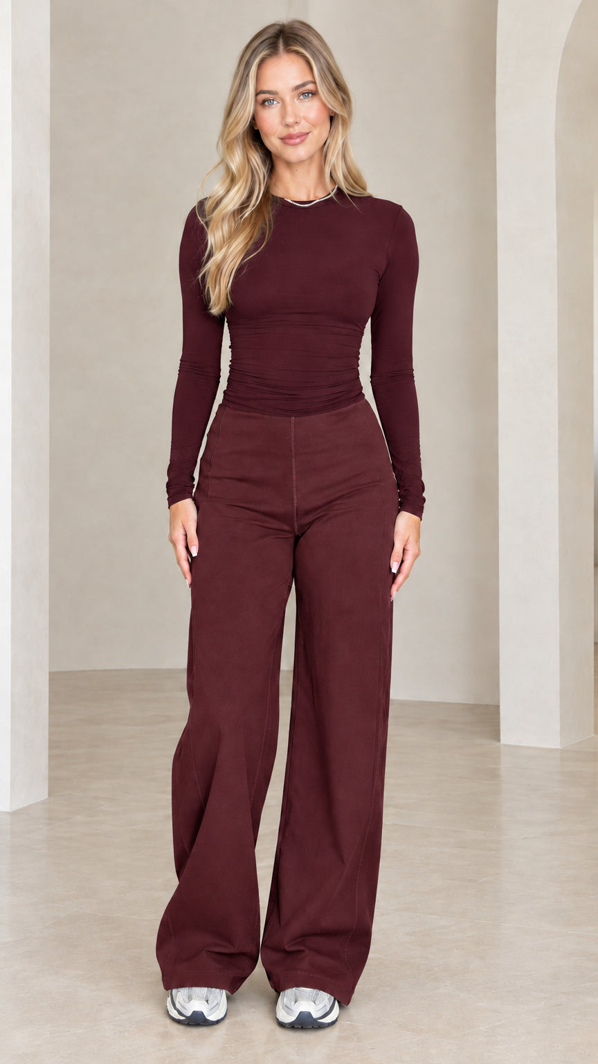 Front full length view of model wearing burgundy ruched top and wide leg pants set