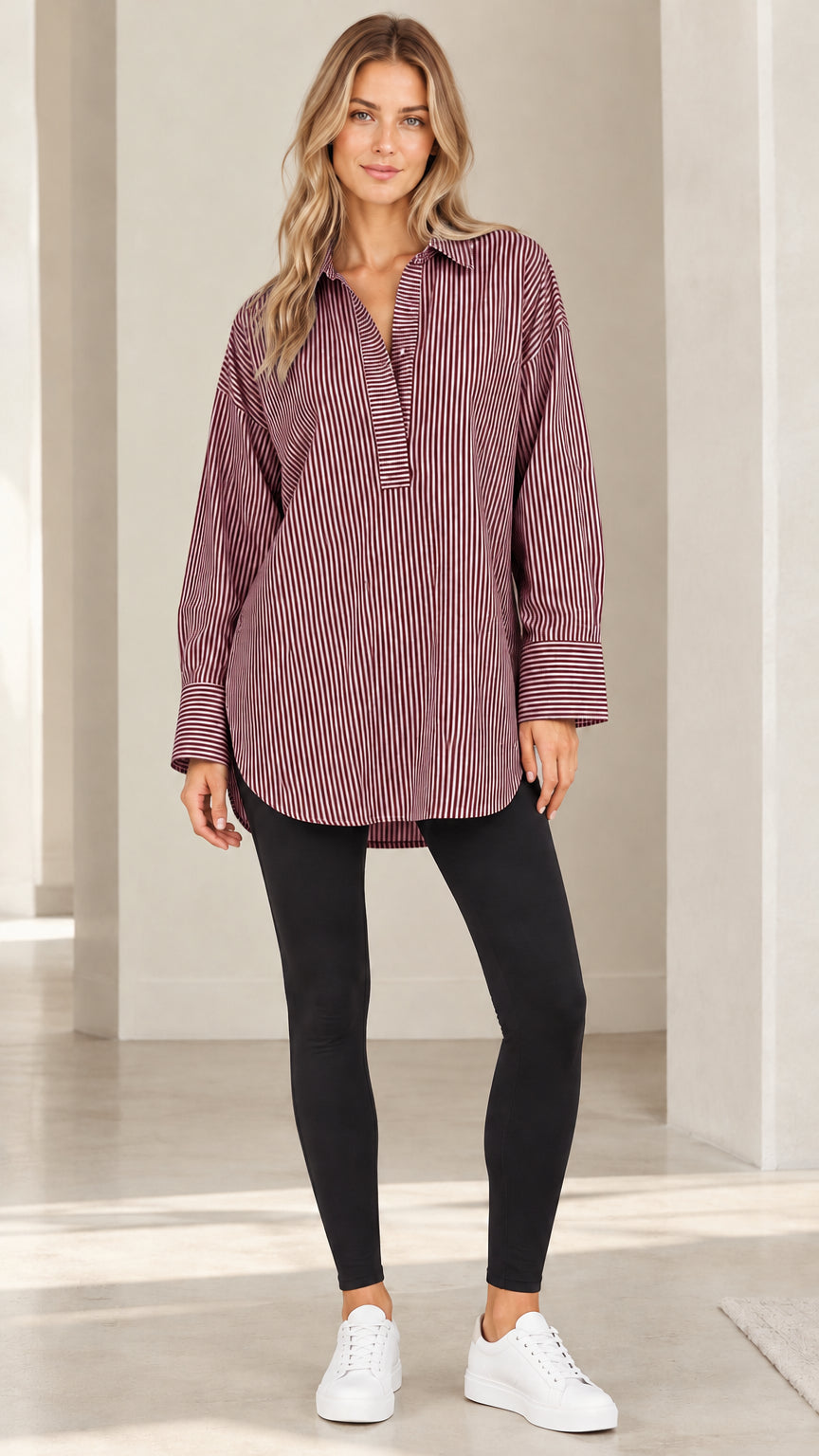 Front view of model wearing burgundy and white vertical striped popover tunic shirt