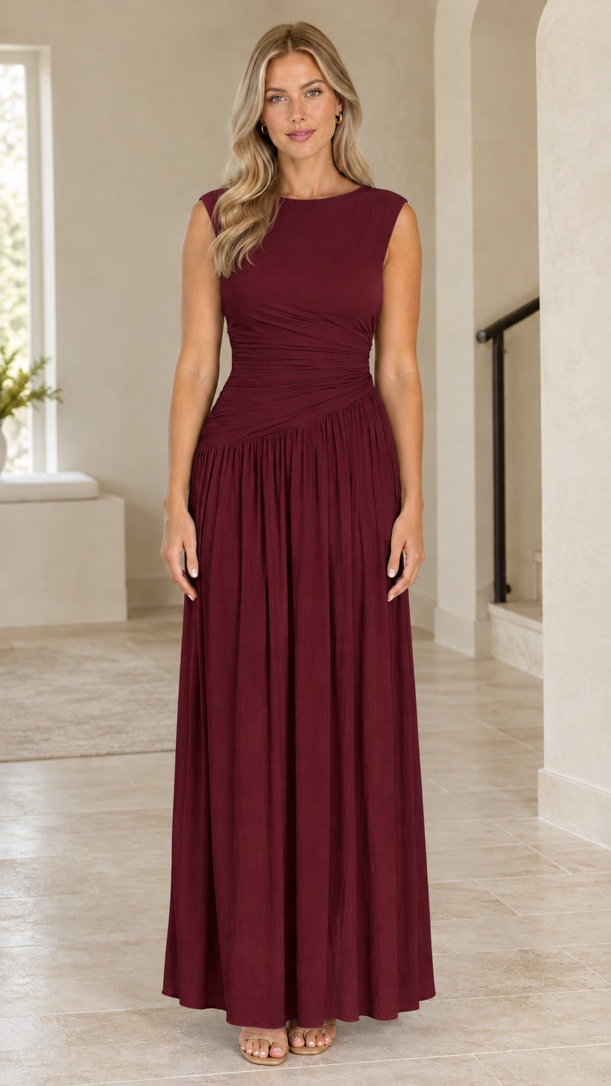 Front view of woman wearing burgundy wine red sleeveless ruched boat neck maxi dress