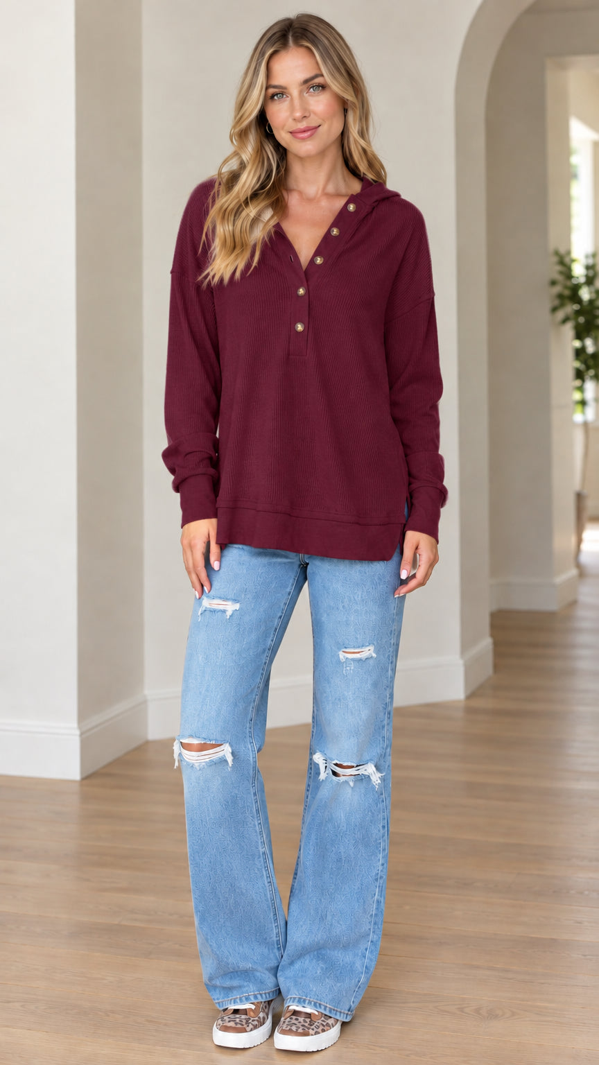 Model wearing burgundy long sleeve waffle knit henley pullover hoodie