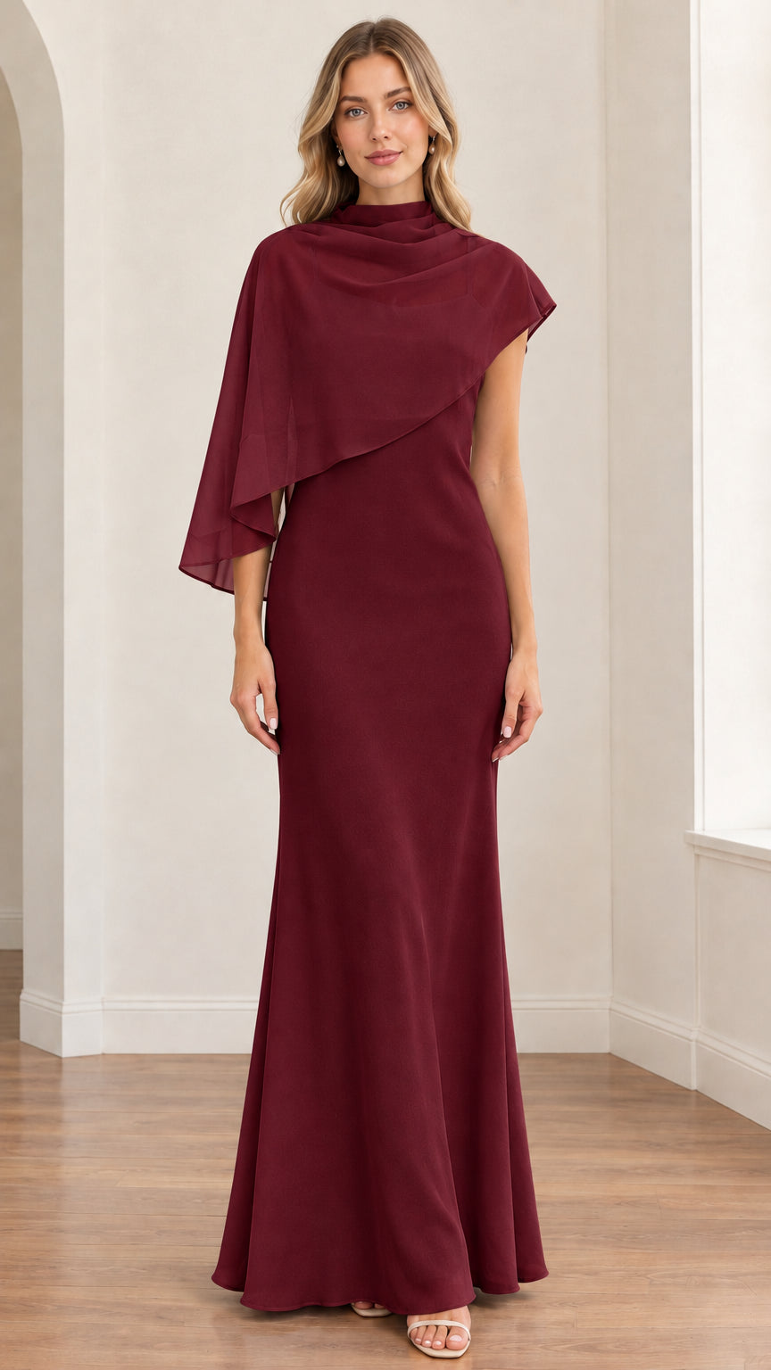 Front view of model wearing the burgundy red asymmetrical capelet formal maxi dress