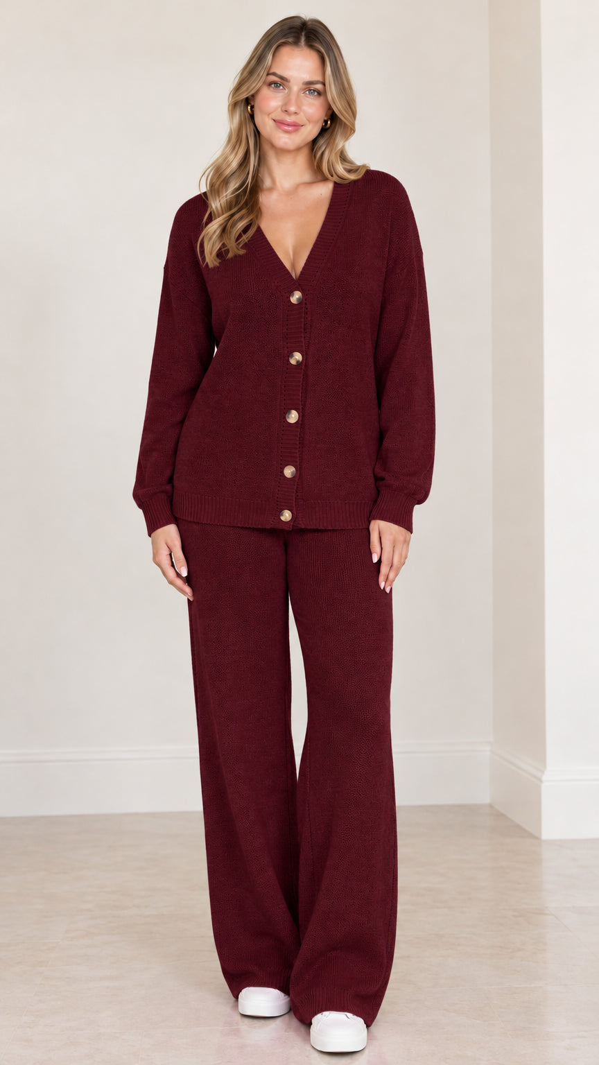 Model wearing burgundy red knit cardigan and wide leg trousers set