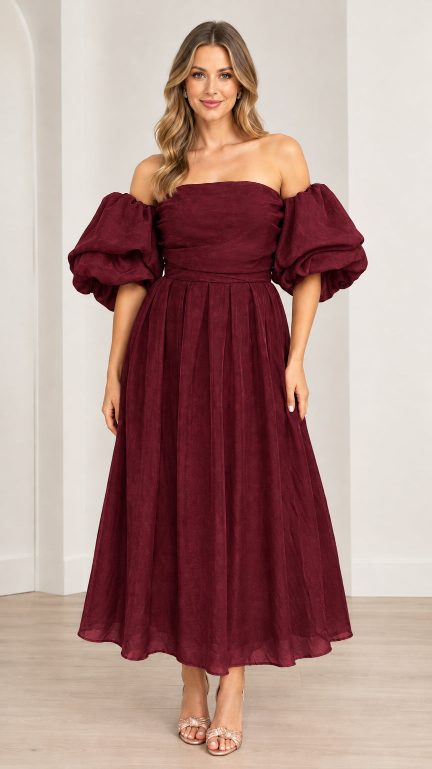 Model wearing off-the-shoulder puff sleeve pleated midi dress in burgundy