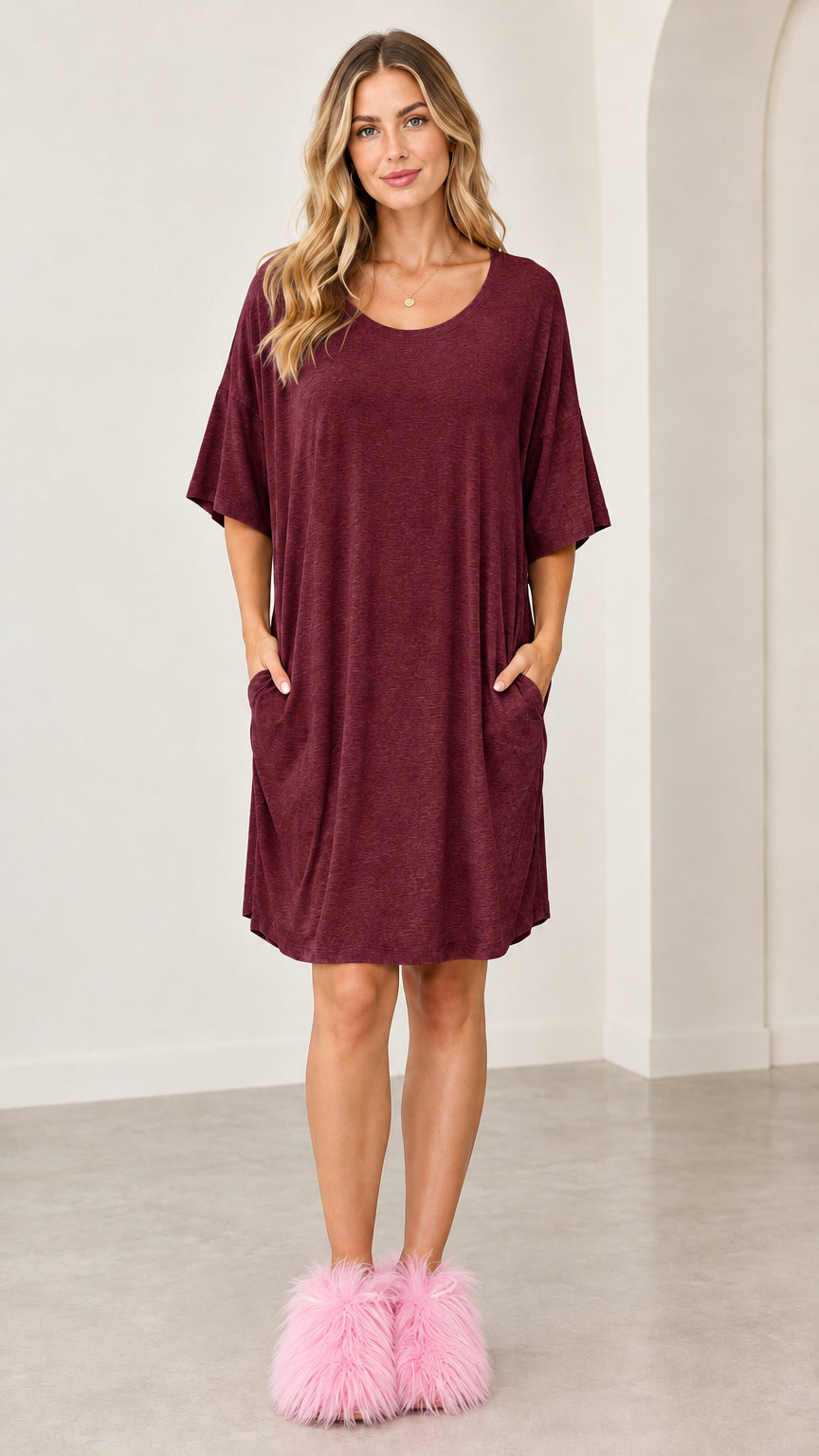 Full front view of the burgundy oversized short sleeve lounge dress with pockets