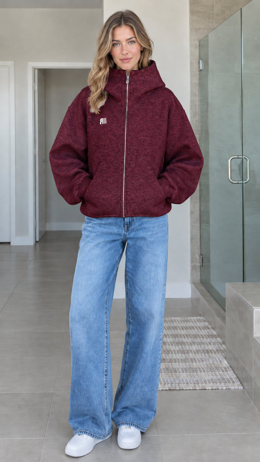 Front view of model wearing burgundy oversized high-neck zip-up fleece hoodie jacket