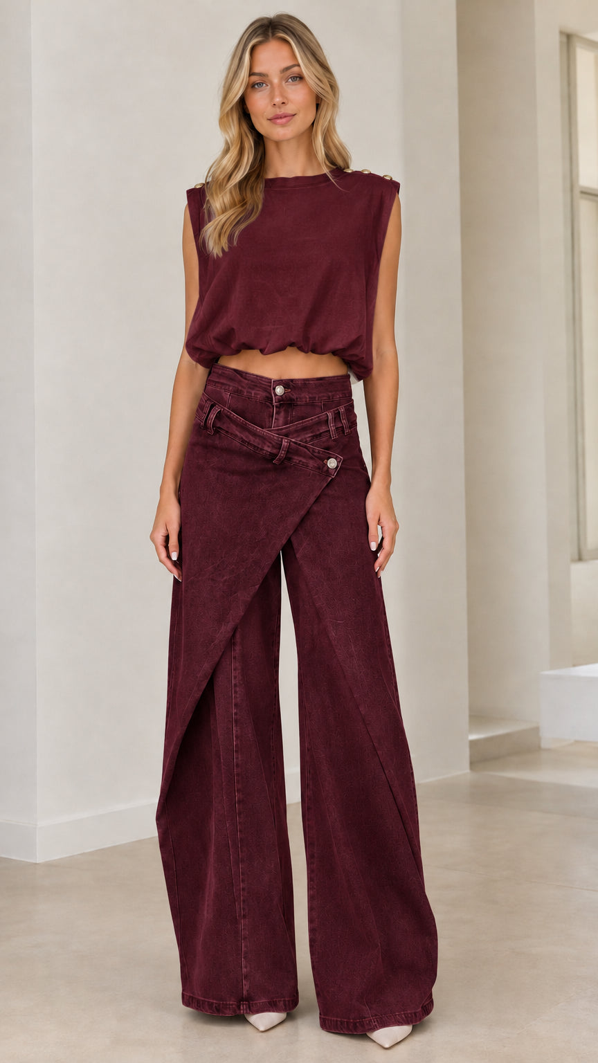 Full front view of model wearing burgundy asymmetrical wrap front wide leg denim pants